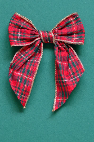 Christmas bow on green paper — Stock Photo, Image