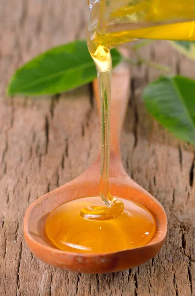 Honey dripping from a jar — Stock Photo, Image