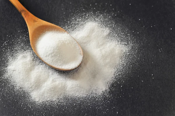 Bicarbonate in a wooden spoon — Stock Photo, Image