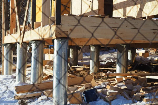 Building a house from a beam on stilts. — Stock Image Building a house from a beam on stilts. Royalty Free Stock Photos