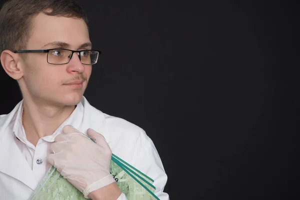 Portrait of a young doctor of European appearance in a white medical gown. Medical student — Stock Photo, Image