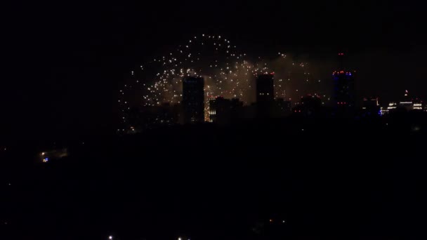 Feestelijk vuurwerk aan de nachtelijke hemel boven de stad. Vuurwerk in de metropool. — Stockvideo