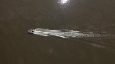 Oka Nehri. Güneşli havada bir motorlu tekne nehir boyunca gider. Hava fotoğrafçılığı. Yüksek kaliteli FullHD görüntüler