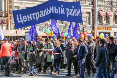 People under the banner of his district.