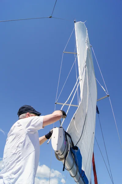 Man working with a sail. — Stock Photo, Image