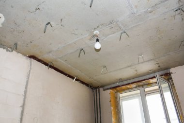 Sahte tavanlar için tavana monte edilmiş askı. Konut binalarının yeni apartmanlarında inşaat ve bitirme işleri.