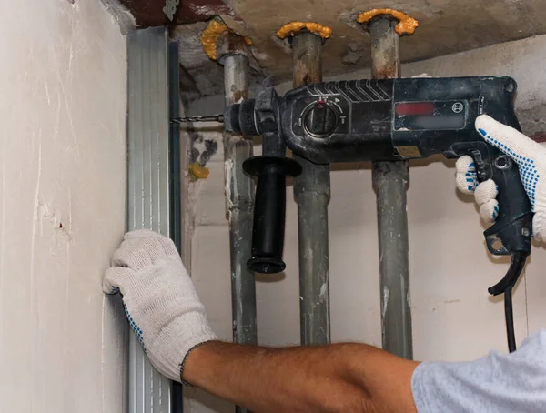 stock image Drilling holes in the wall through the rack.