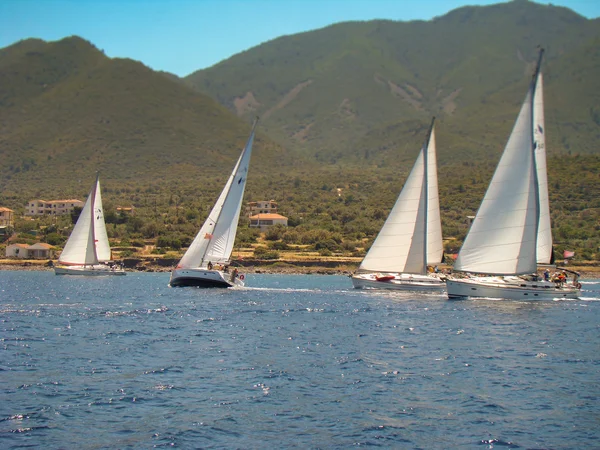 Yachts passing by the coast — Stock Photo, Image