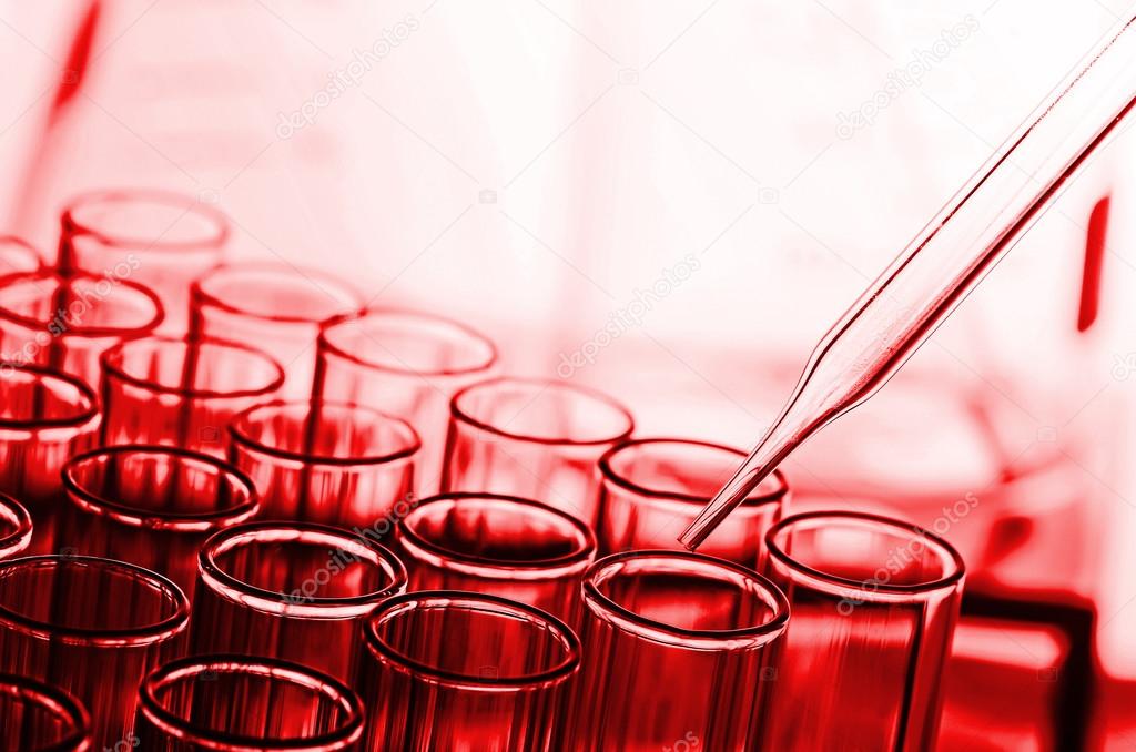 science laboratory test tubes in red tone