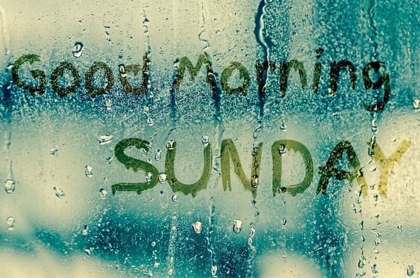 Natural water drops on glass window with word "Good morning sund — Stock Photo, Image