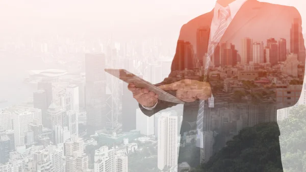 Double exposure of business man using tablet and night modern ci — Stock Photo, Image