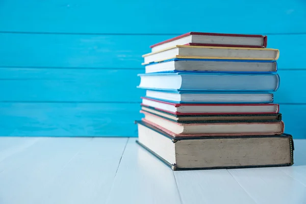 book stack with blue wooden wall background