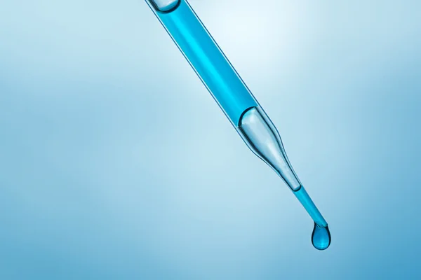 Science laboratory pipette with a drop of chemical — Stock Photo, Image