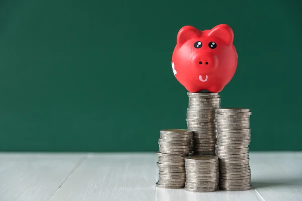 Red piggy bank on coin stack — Stock Photo, Image