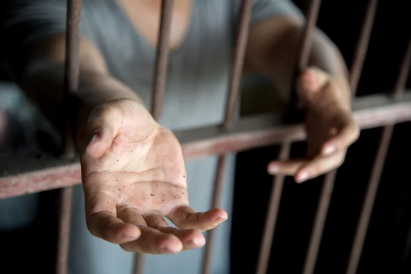 prisoner with begging hand in jail