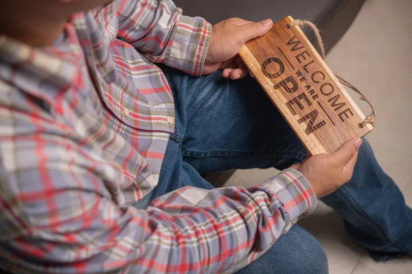 Man Sitting His Hand Holding Open Signboard Reopening Concept — Stock Photo, Image