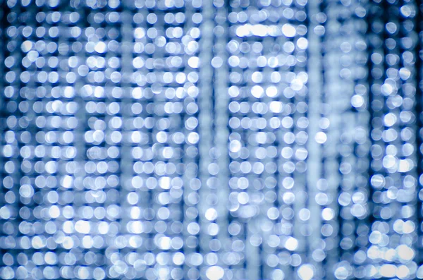 Schöne Bokeh-Lichter auf blauem Hintergrund — Stockfoto