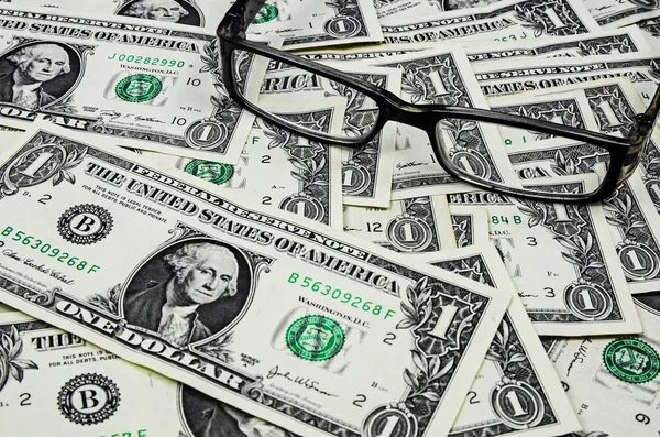 Glasses on dollars background — Stock Photo, Image