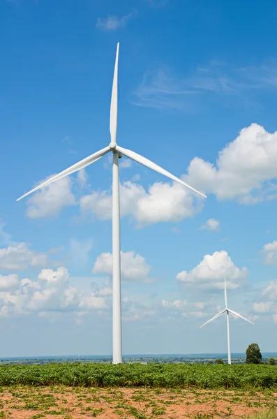 Wind turbine against cloudy blue sky background — Stock Photo, Image