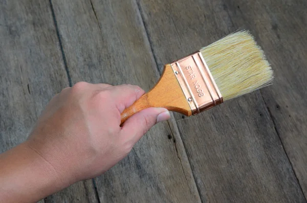 paint brush in worker hand