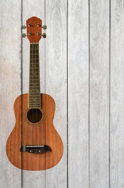 Ukelele guitarra sobre fondo de madera — Foto de Stock