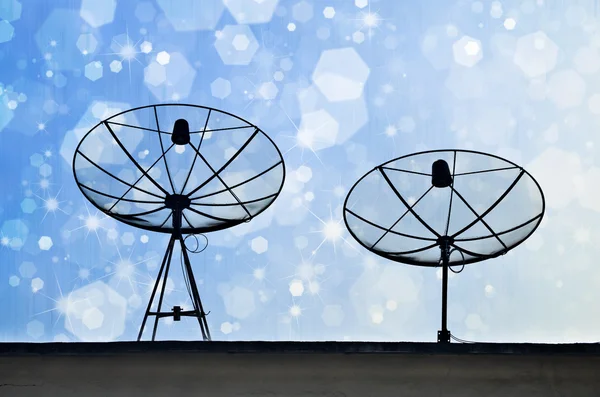 Satellite Dishes on rooftop with Chirstmas bokeh background — Stock Photo, Image