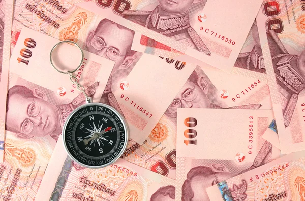 Thai money and a compass — Stock Photo, Image