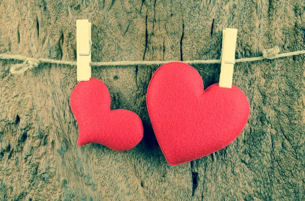 Lovely red hearts hanging on the clothesline on old wood backgro — Stock Photo, Image