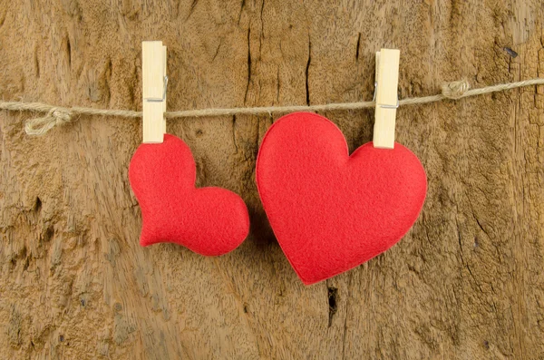 Lovely red hearts hanging on the clothesline on old wood backgro — Stock Photo, Image