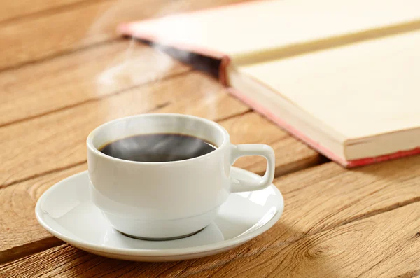 Copo de café branco com fumaça e grãos de café ao redor — Fotografia de Stock