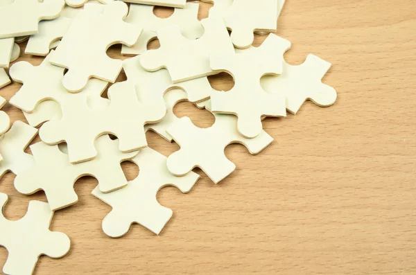 Jigsaw puzzle pieces on wood background — Stock Photo, Image