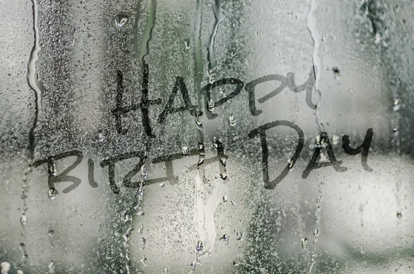 Natural water drops on glass window with the text Happy birth day — Stock Photo, Image