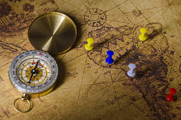 Compass with marked location on old map — Stock Photo, Image