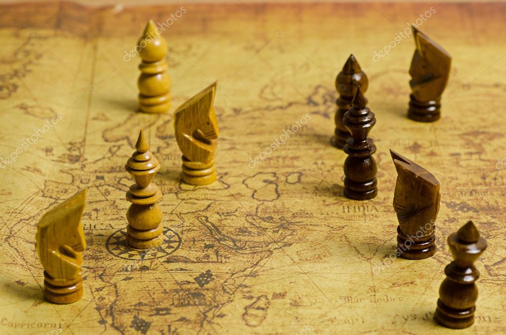 Compass and Chess on old map Stock Photo by ©kwanchaidp 75914583