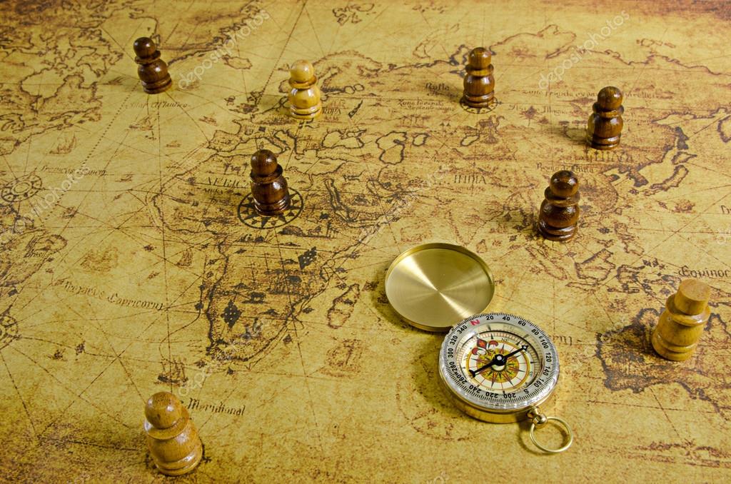 Compass and Chess on old map Stock Photo by ©kwanchaidp 75914583