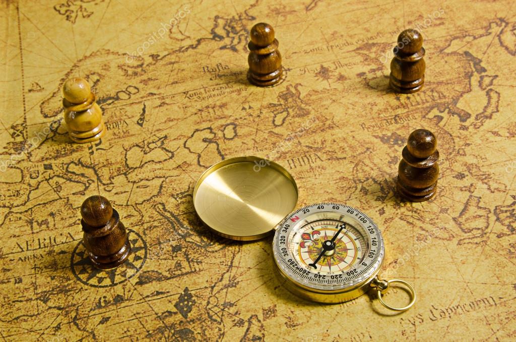 Compass and Chess on old map Stock Photo by ©kwanchaidp 75914583