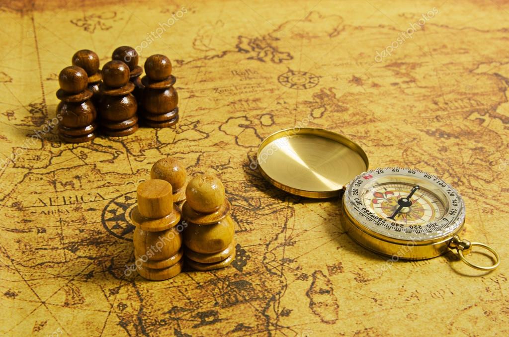 Compass and Chess on old map Stock Photo by ©kwanchaidp 75914583