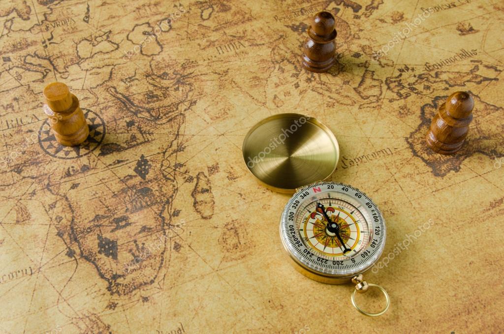 Compass and Chess on old map Stock Photo by ©kwanchaidp