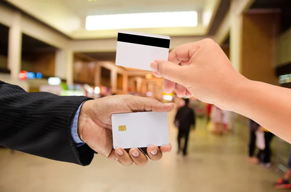 Hand holding a blank smart card on blur background — Stock Photo, Image