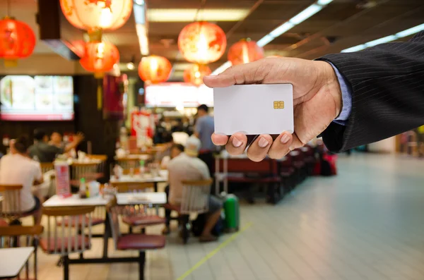 Hand holding a blank smart card on blur background — Stock Photo, Image