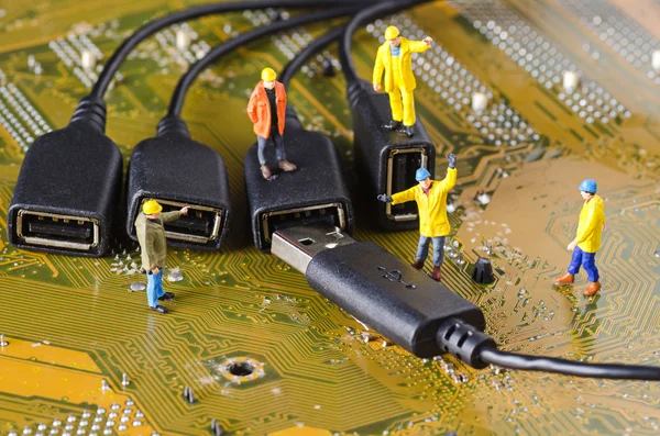 Miniature Technicians try to connecting data cable — Stock Photo, Image