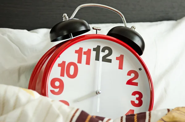 Alarm clock sleeping in bed — Stock Photo, Image