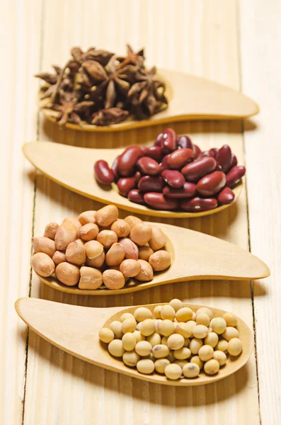 Beans in wooden spoon on wood table — Stock Photo, Image