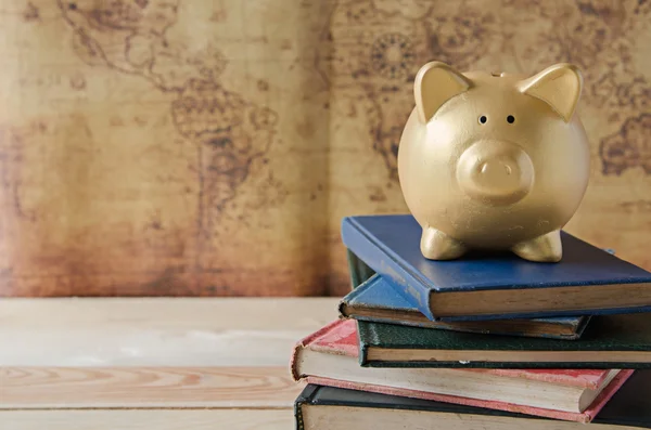 Gold piggy bank on stack of book — Stock Photo, Image