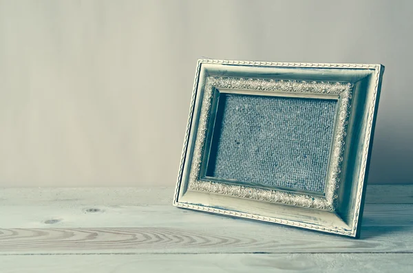 Blank photo frame on wooden table — Stock Photo, Image