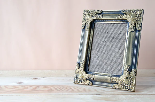 Blank photo frame on wooden table — Stock Photo, Image