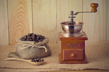 Coffee grinder on wooden table clipart
