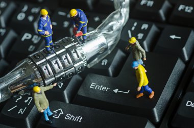 miniature people try to unlock metal security lock key clipart