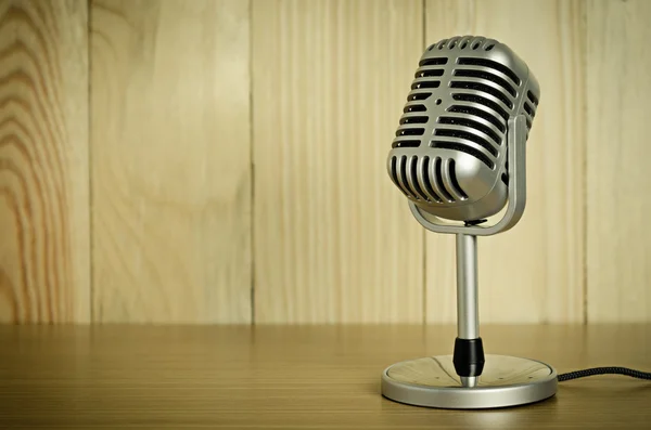 stock image microphone on wooden table