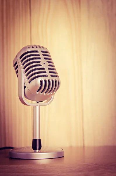 stock image microphone on wooden table